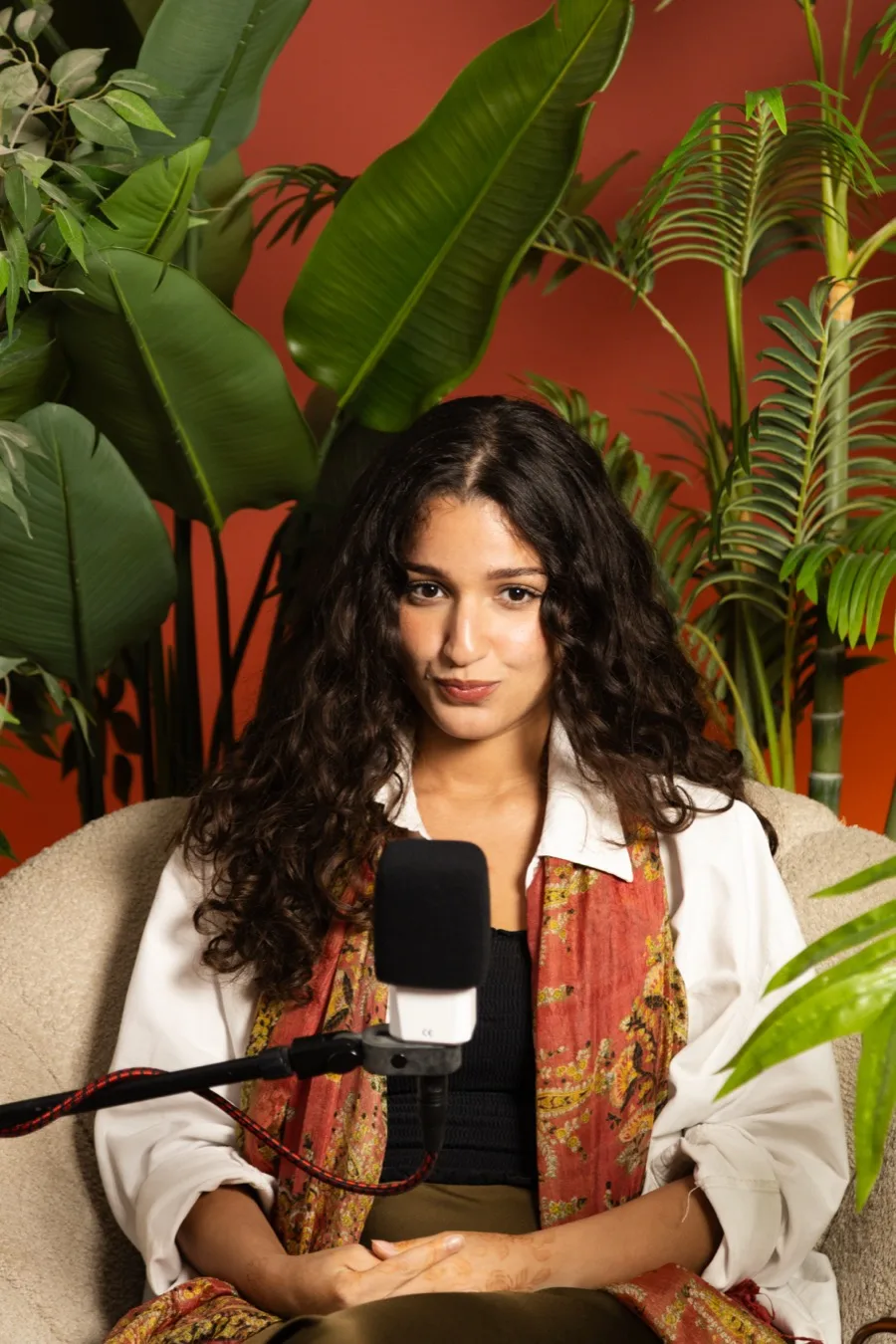 A member of the Tiempo team sitting at a studio microphone
