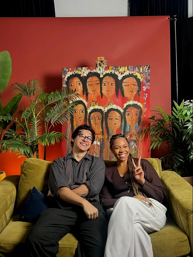 Sam Brown, Tiempo's founder, sitting on a couch with a Tiempo client