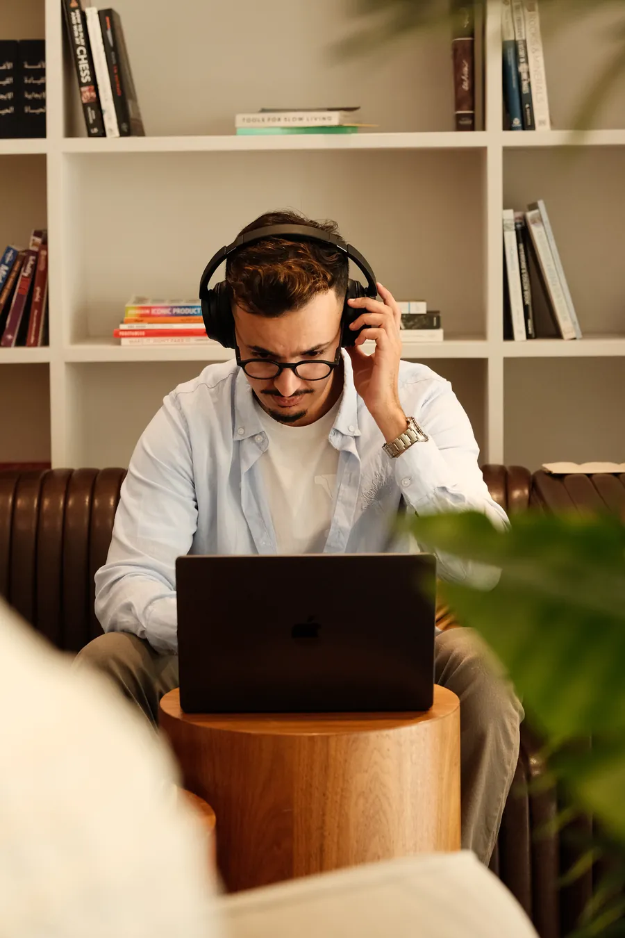 A Tiempo team member focused on deep work at a laptop with headphones on