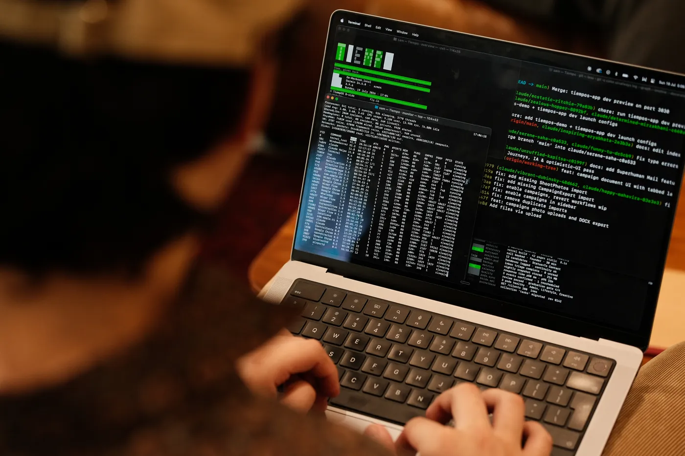 Over-the-shoulder view of a laptop running the Tiempo terminal dashboard