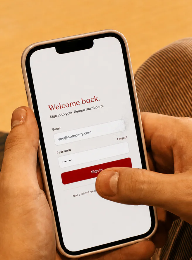 A Tiempo team member signing in to the Tiempo dashboard on a phone
